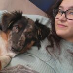 Amber holding a brown speckled dog
